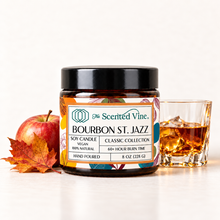 Load image into Gallery viewer, Bourbon St. Jazz Soy Candle with a small apple, maple leaf, and modest unbranded bourbon glass