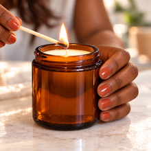 Load image into Gallery viewer, Black woman's hands lighting a Classic amber soy candle